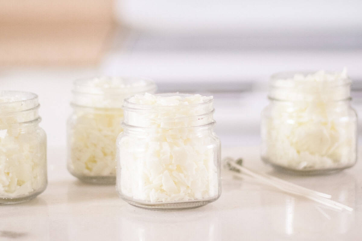 Candle jars filled with wax pellets.