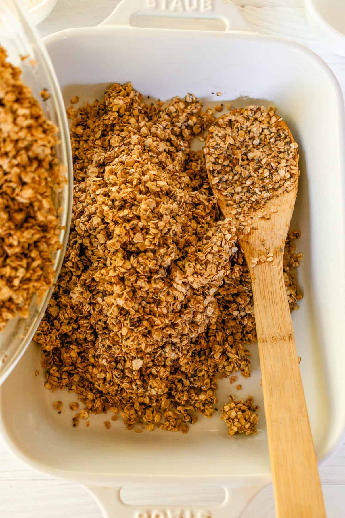 Stirring the granola in a bowl.