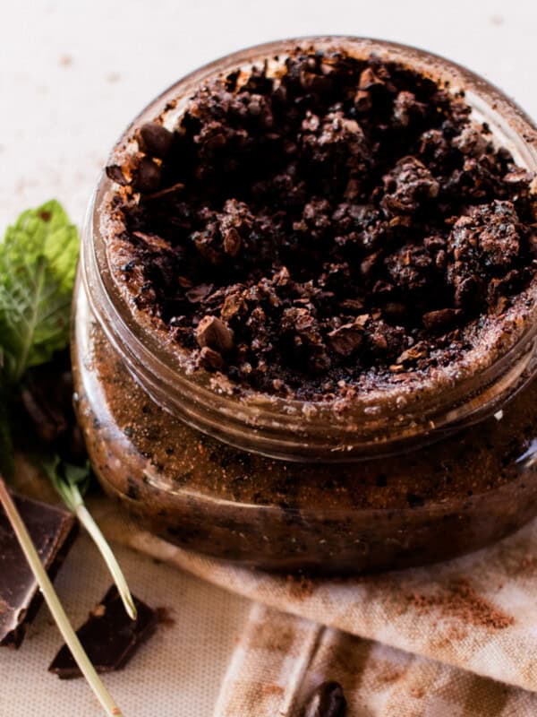 Peppermint face scrub with ground coffee in a decorative jar with hemp string tied around it with a beautiful label.