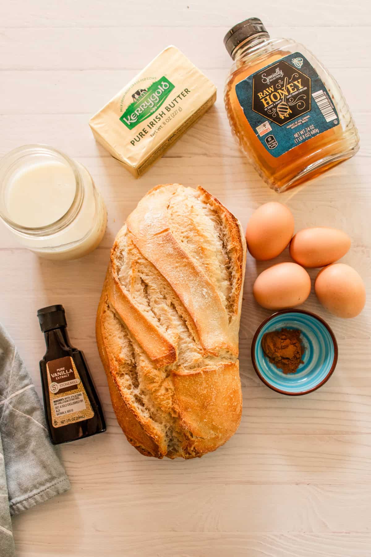 Sourdough french toast ingredients on a white backdrop.