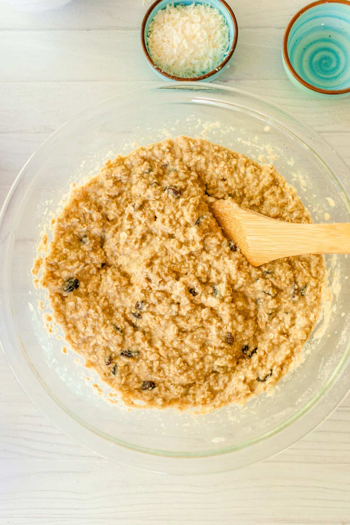 Stirring the raisins into the batter with a wooden spatula. 