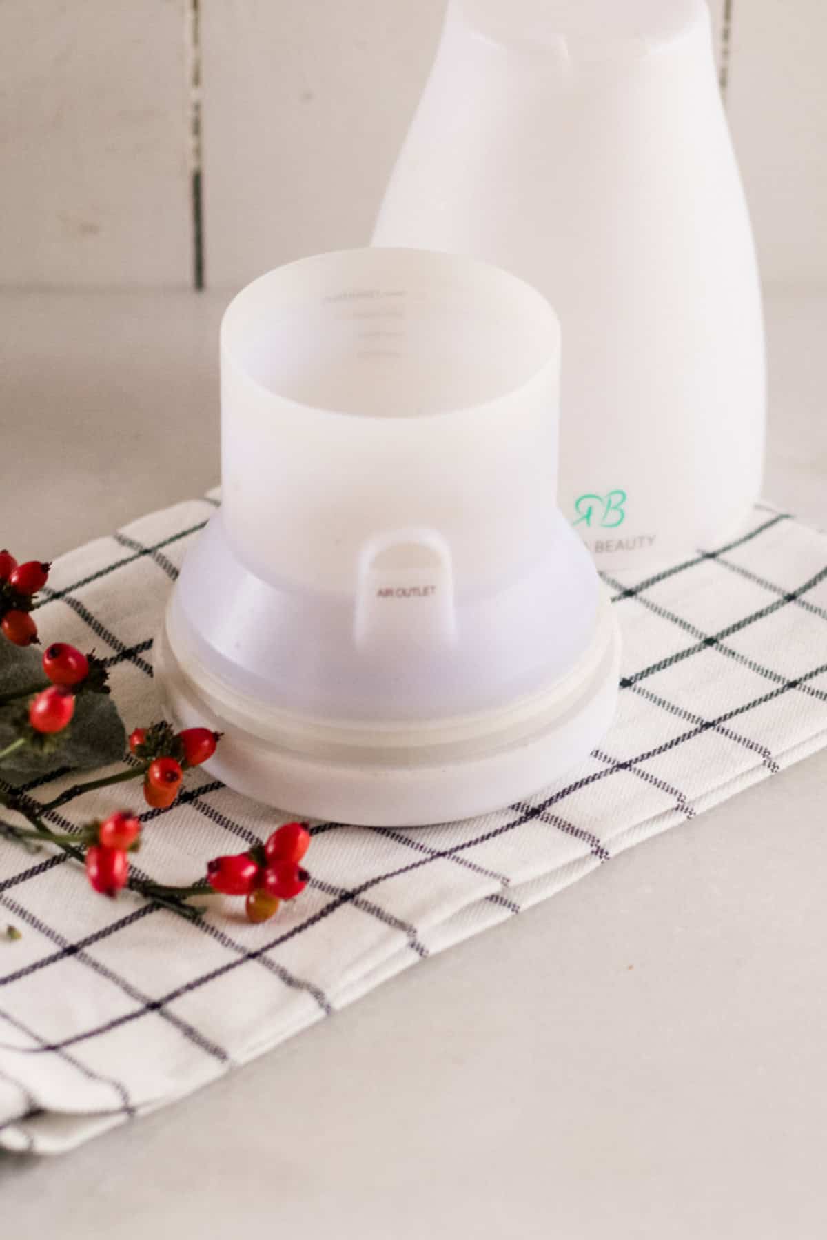 A diffuser on a plaid towel.