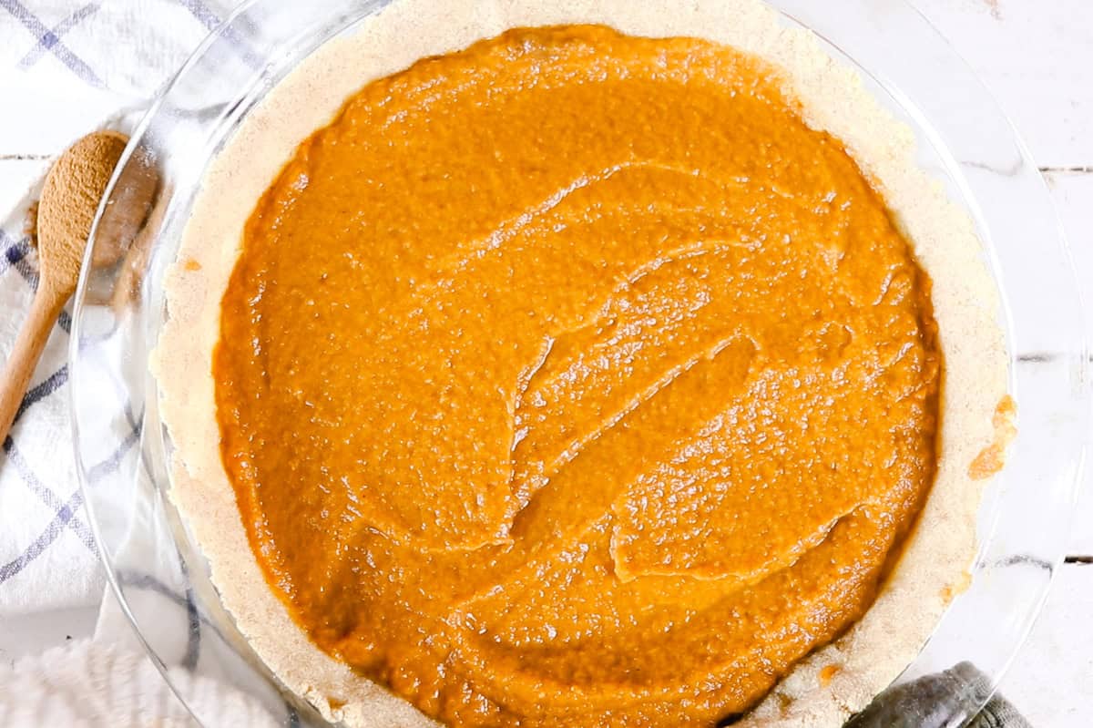 A healthy pumpkin pie with the filling spread in the crust.