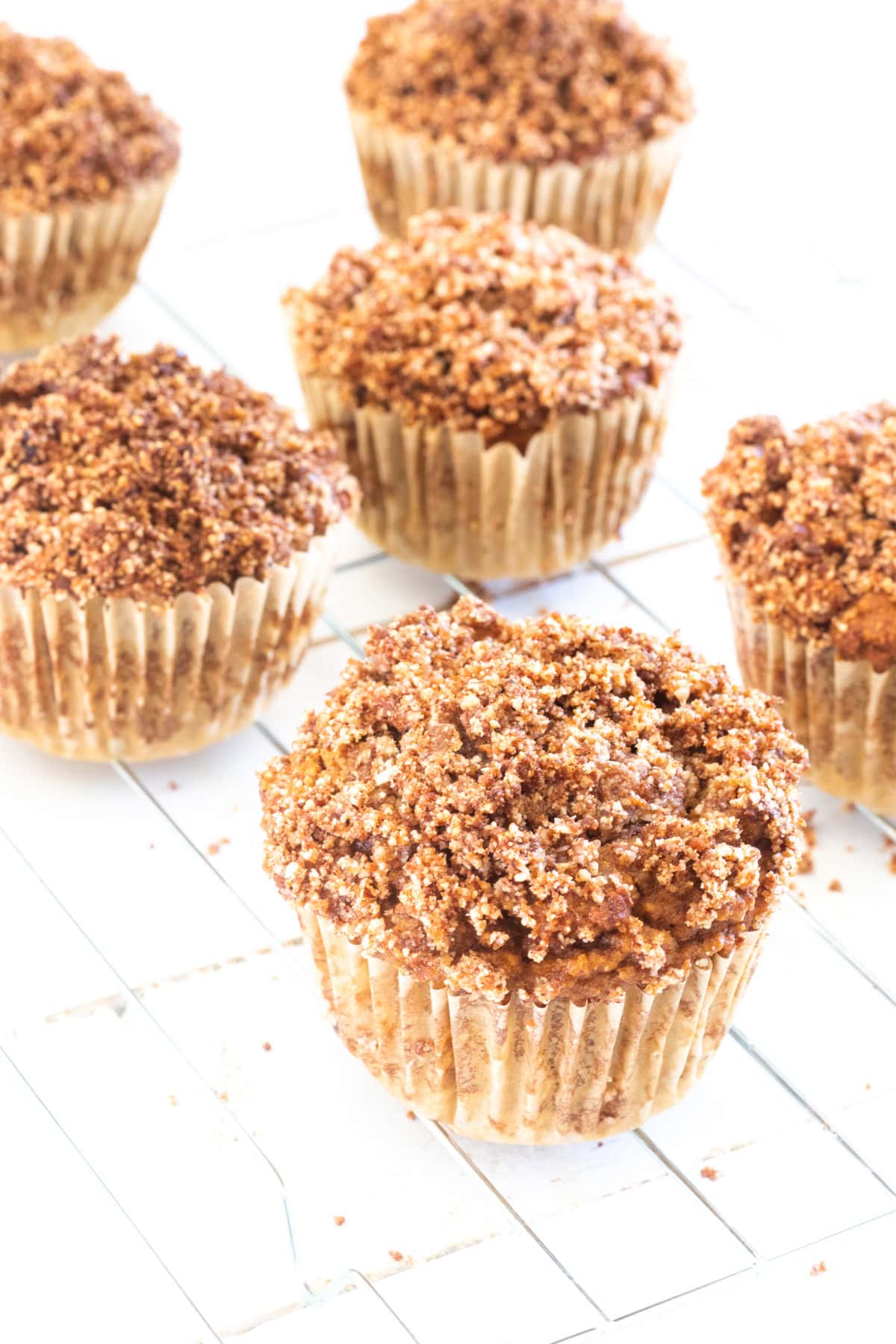 Several pumpkin muffins cooling on a wire cooling rack. 