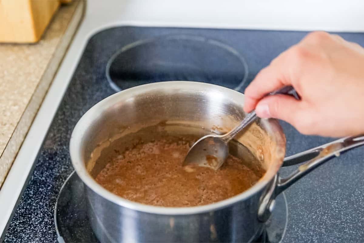 Stirring a pot of paleo hot chocolate on the stove.