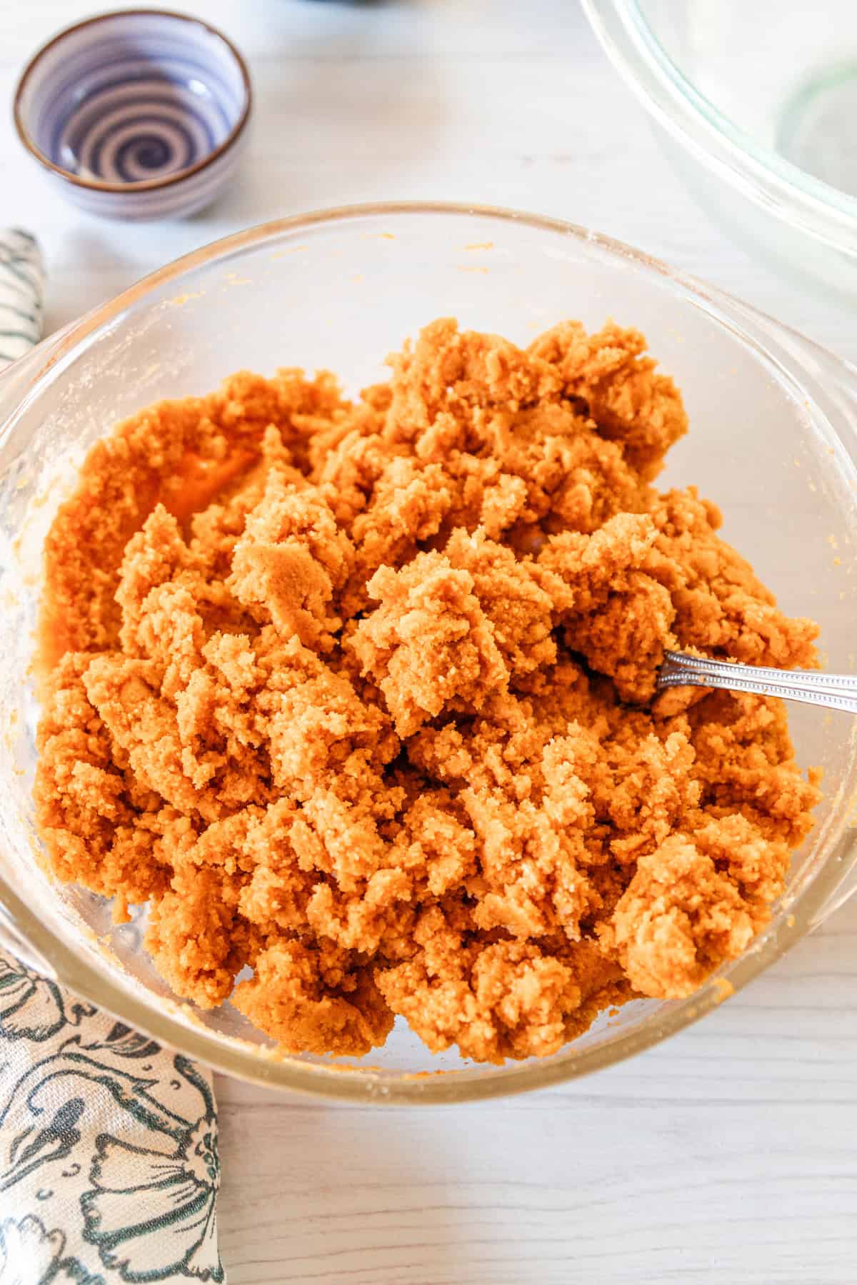Combining the wet and dry ingredients with a metal spoon. 