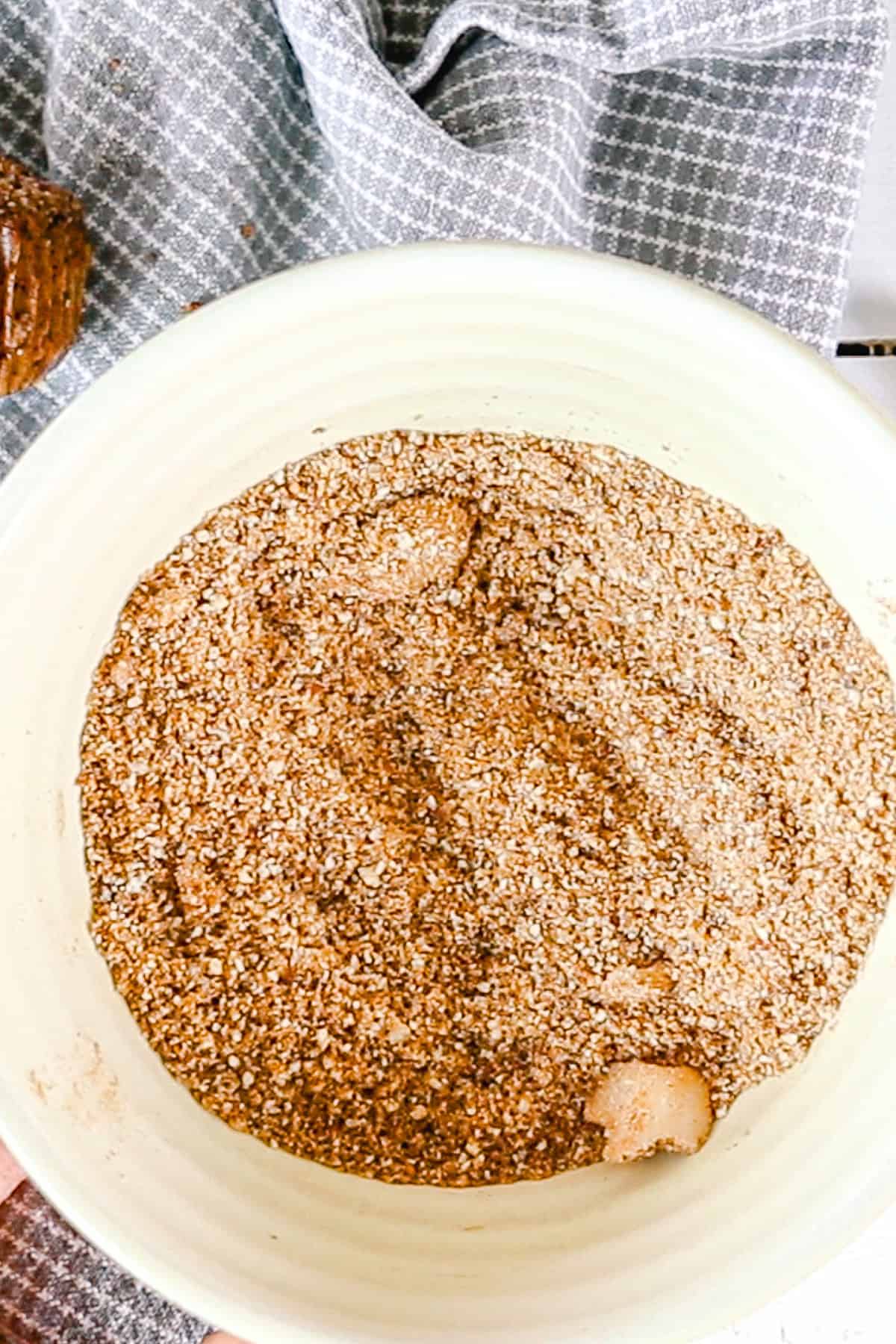 Crumble ingredients to top the muffins with are being combined in a small bowl. 
