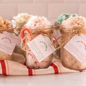 Christmas sugar scrubs with handmade labels tied to the top.