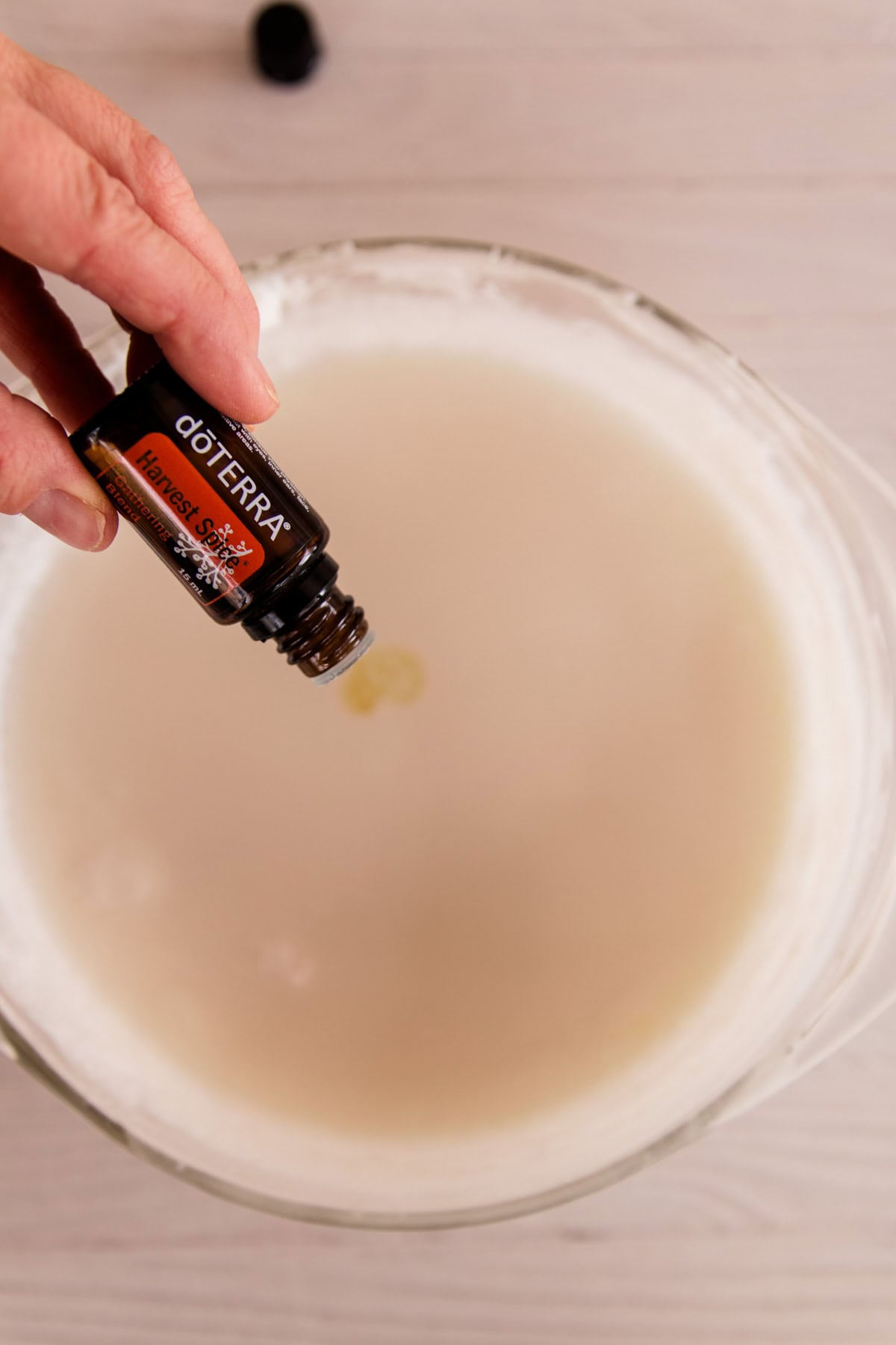 Adding essential oils to melted soap base.