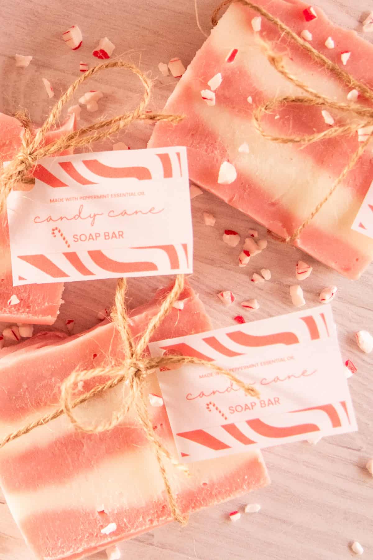 Three candy cane soap bars tied with hemp twine and a gift tag.