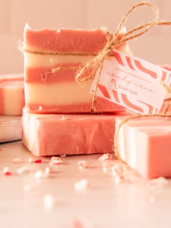 A stack of candy cane soap bars tied with hemp twine and a gift tag.