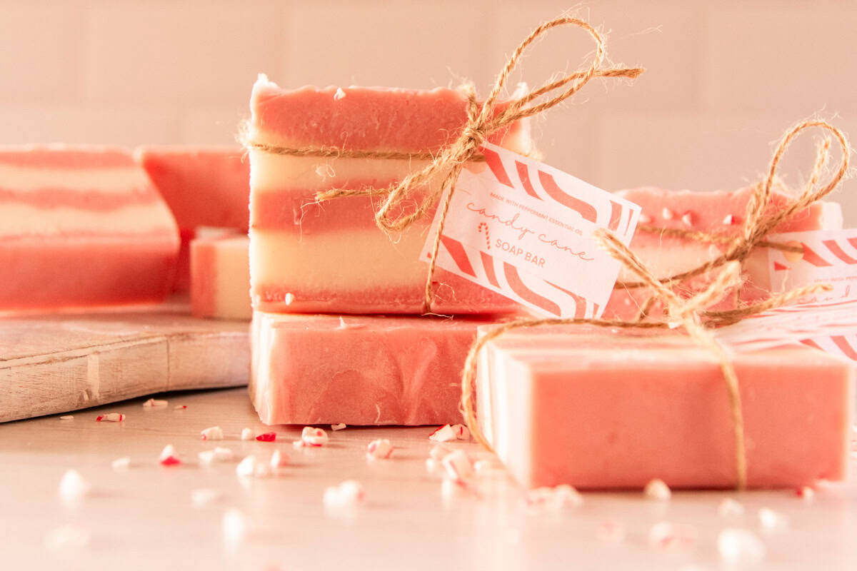 A stack of candy cane soap bars tied with hemp twine and a homemade gift tag. 