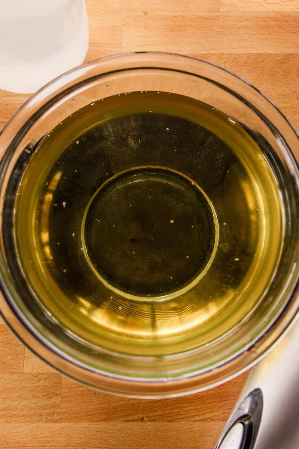 Melted oils and lard in a glass bowl. 