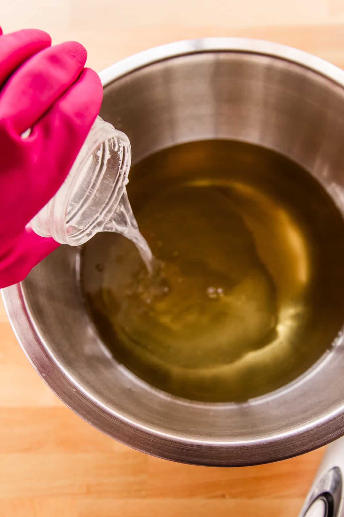 Pouring the lye and water mixture into the melted oils. 