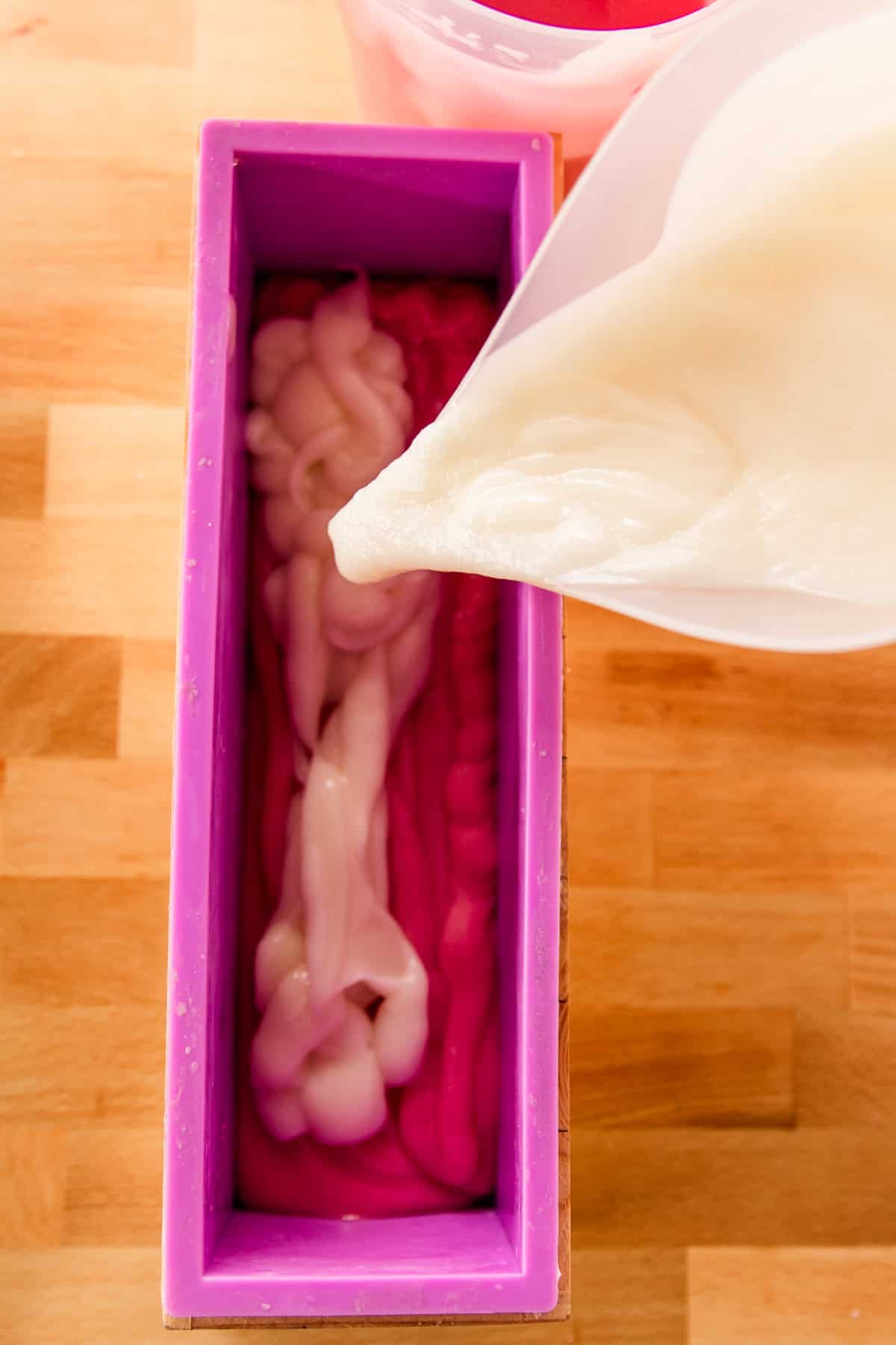 Pouring soap into silicone soap molds.
