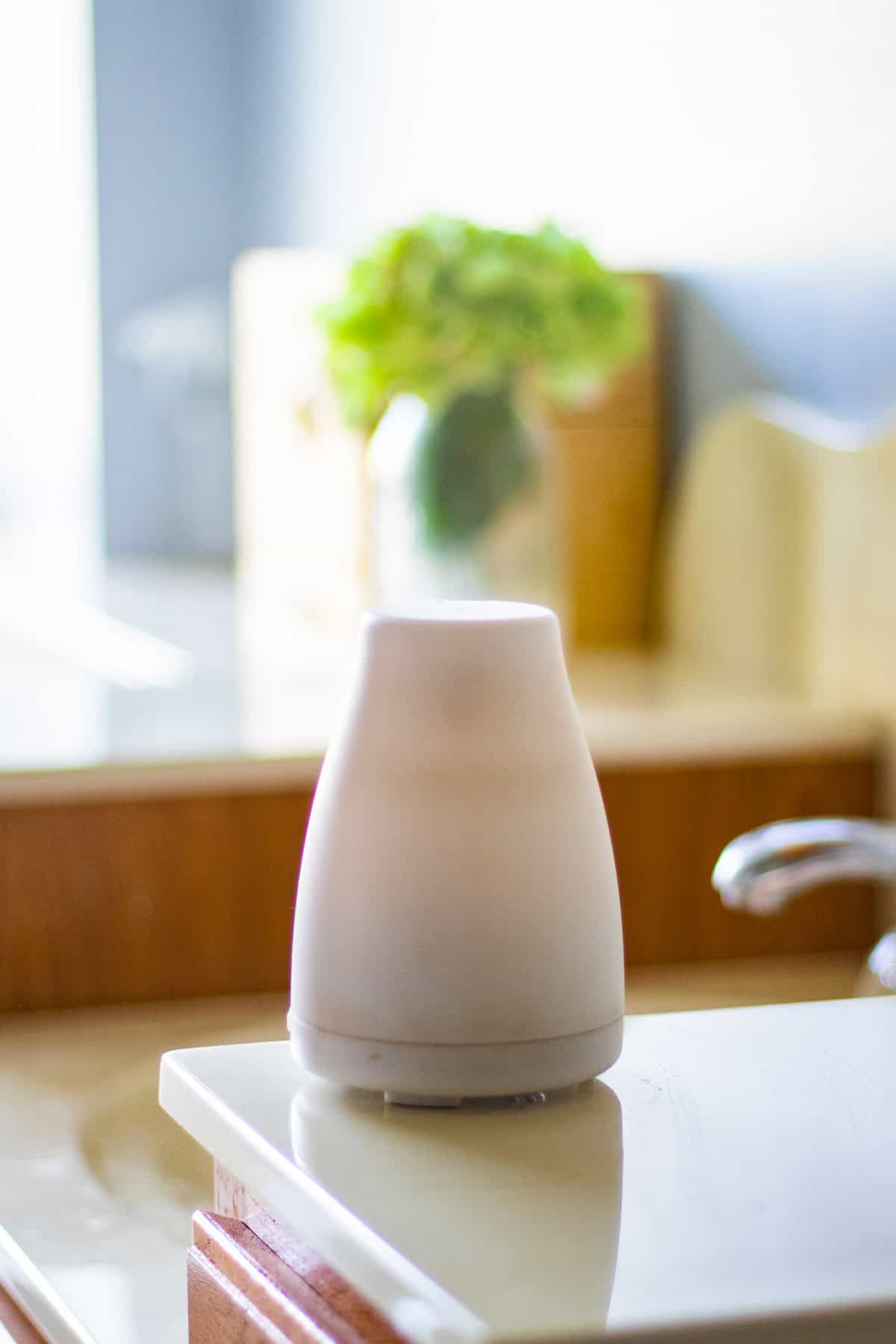 An essential oil diffuser on a kitchen counter.