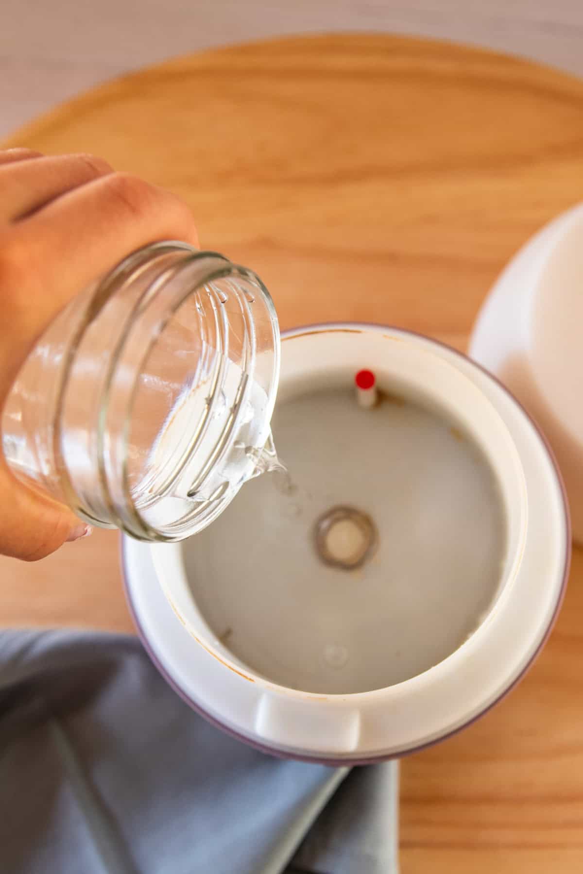 Pouring water into a diffuser.