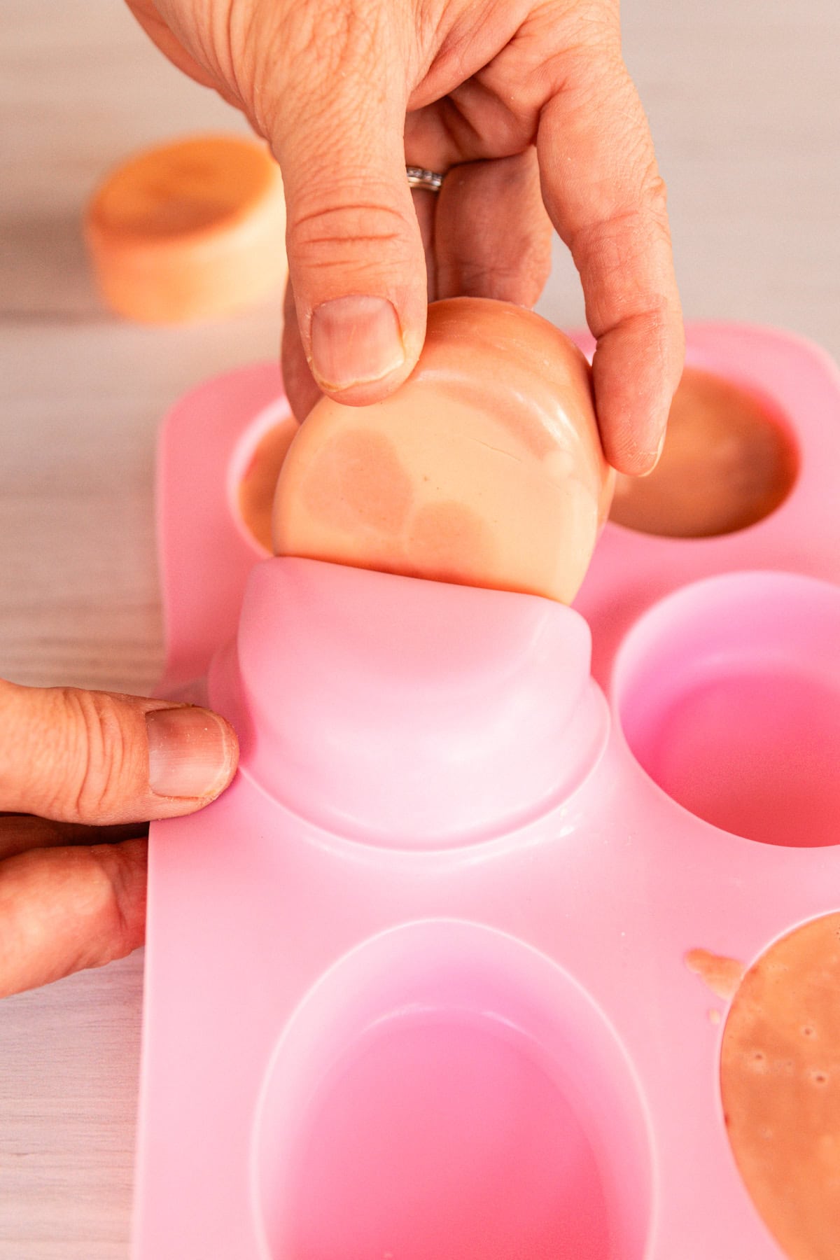 Pulling hardened soap out of the silicone soap mold.