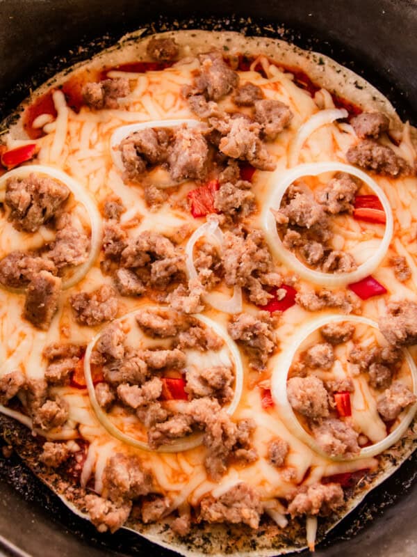 Sausage sourdough pizza fully baked in a cast iron skillet.