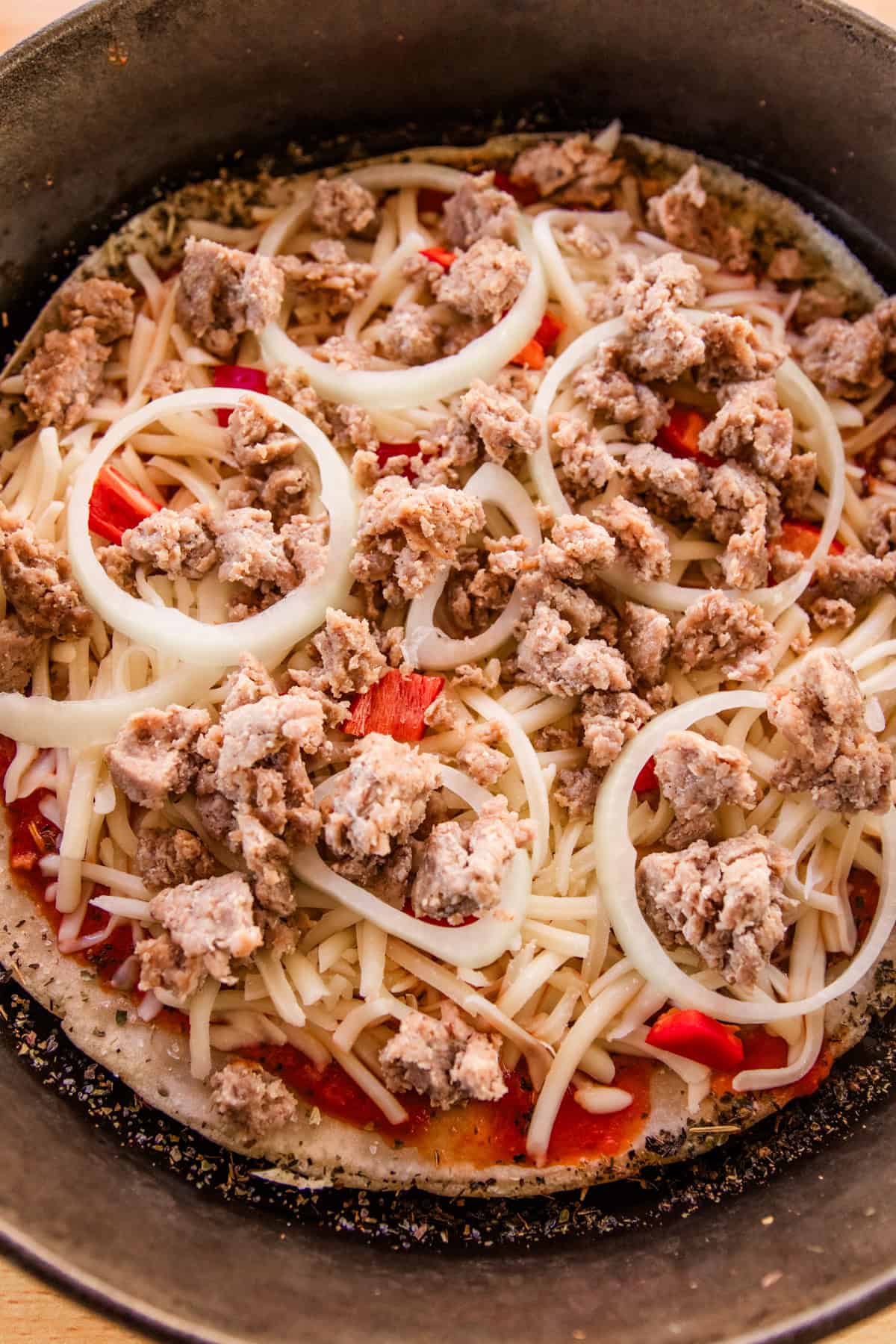 Sausage and onions on a sourdough pizza.