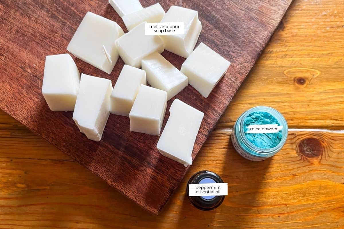 Peppermint soap bar ingredients on a wooden table.