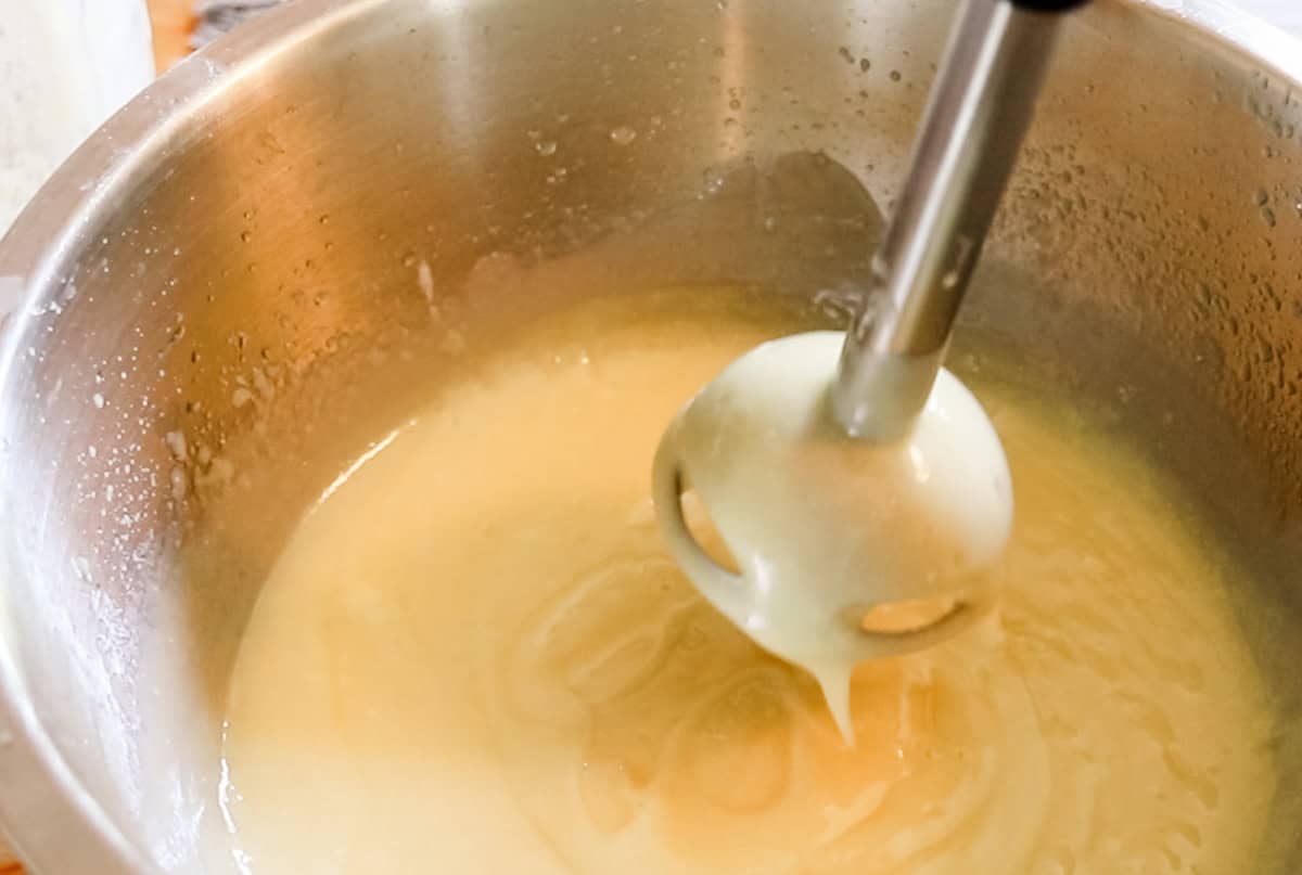 Soap being mixed with an immersion blender.