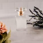 A glass bottle of homemade perfume with flowers.