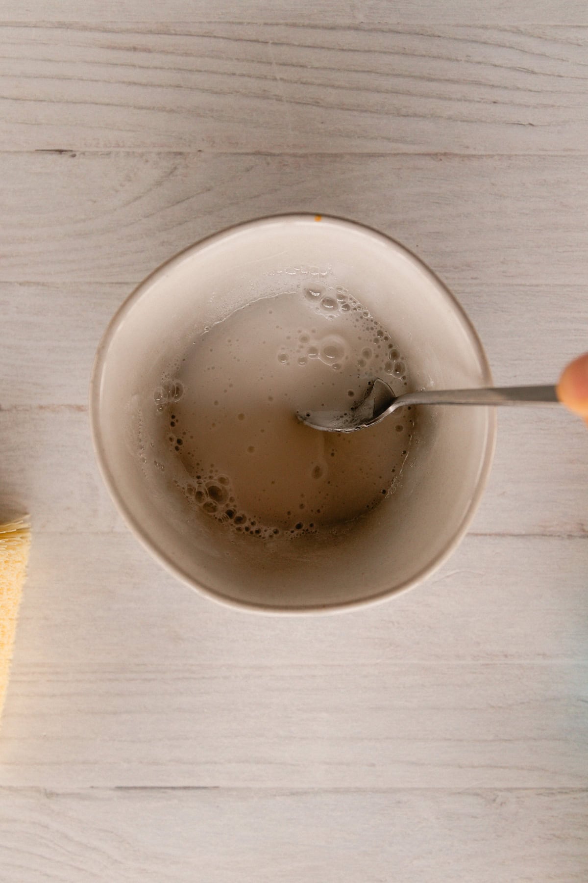 Stirring ingredients in a bowl with a spoon.