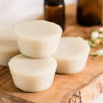 Muscle rub lotion bars on a wooden board.