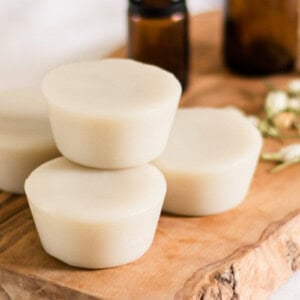 Muscle rub lotion bars on a wooden board.