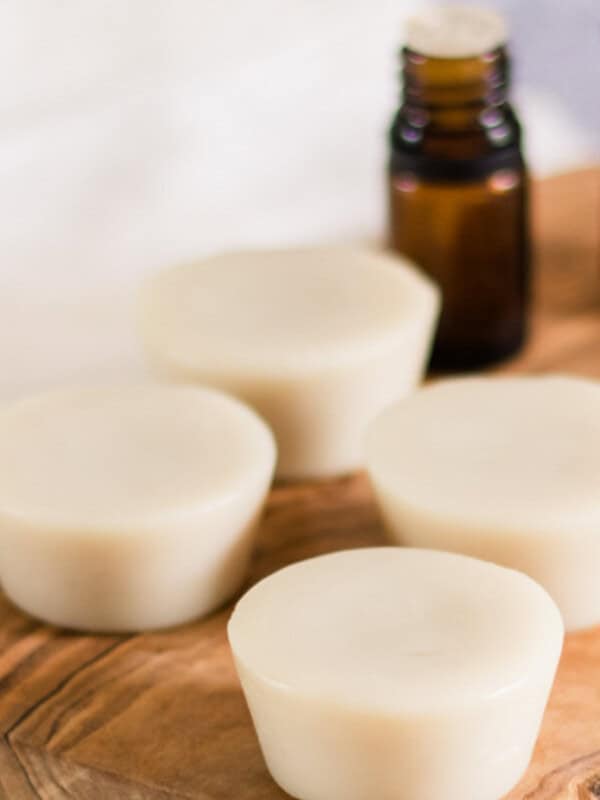Muscle rub lotion bars on a wooden board.