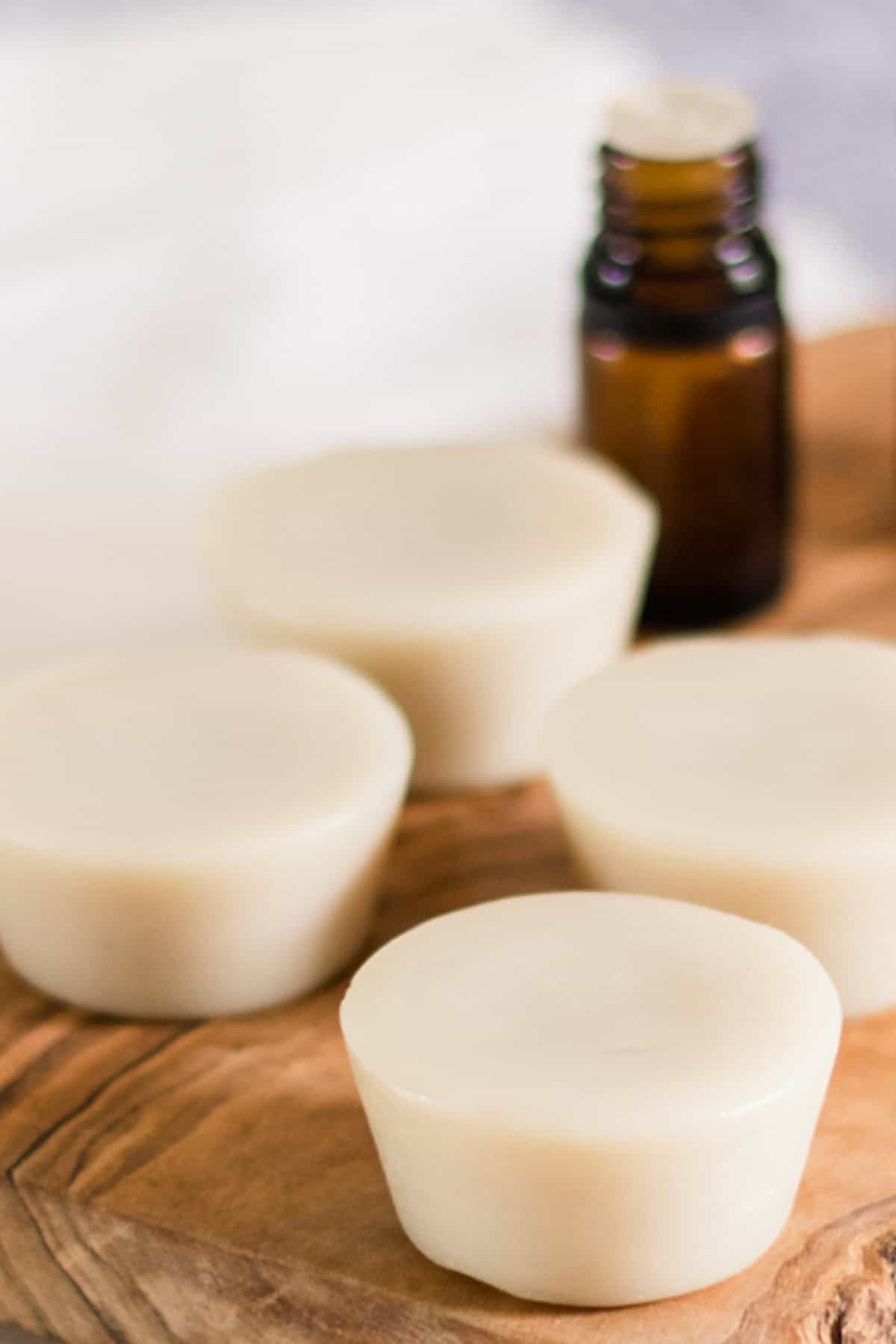 Muscle rub lotion bars on a wooden board.