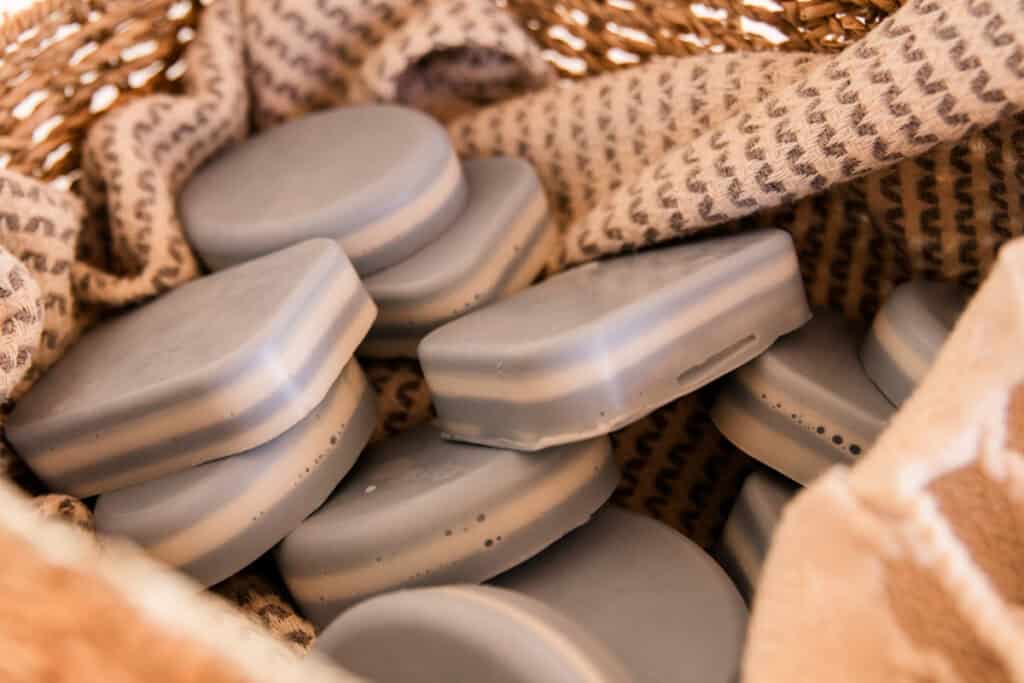 A basket full of peppermint layered soap bars.