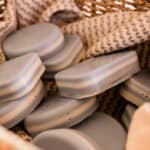 A basket full of peppermint layered soap bars.