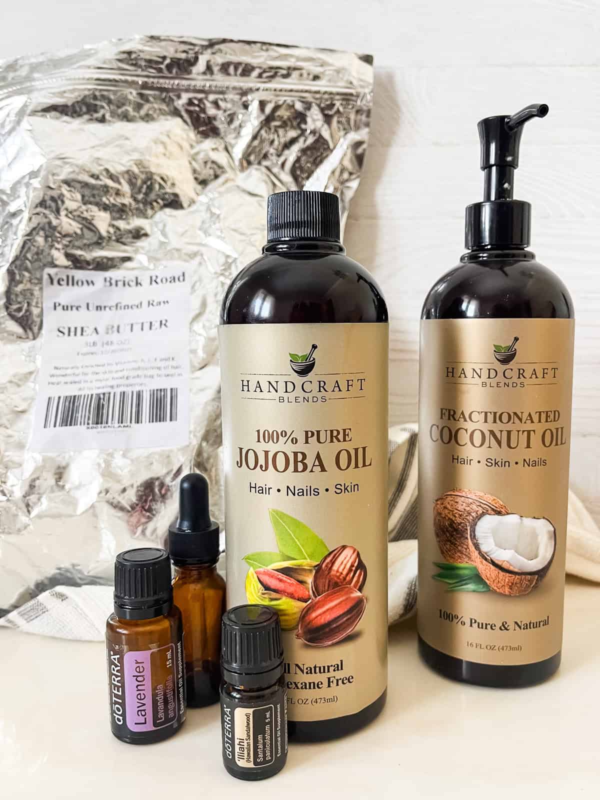Ingredients for the homemade face moisturizer laid out on a marble vanity.