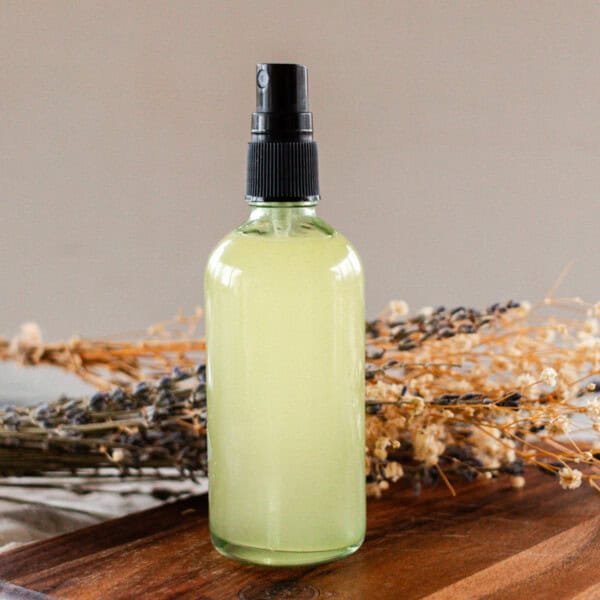 A bottle of whole body deodorant on a wooden board.