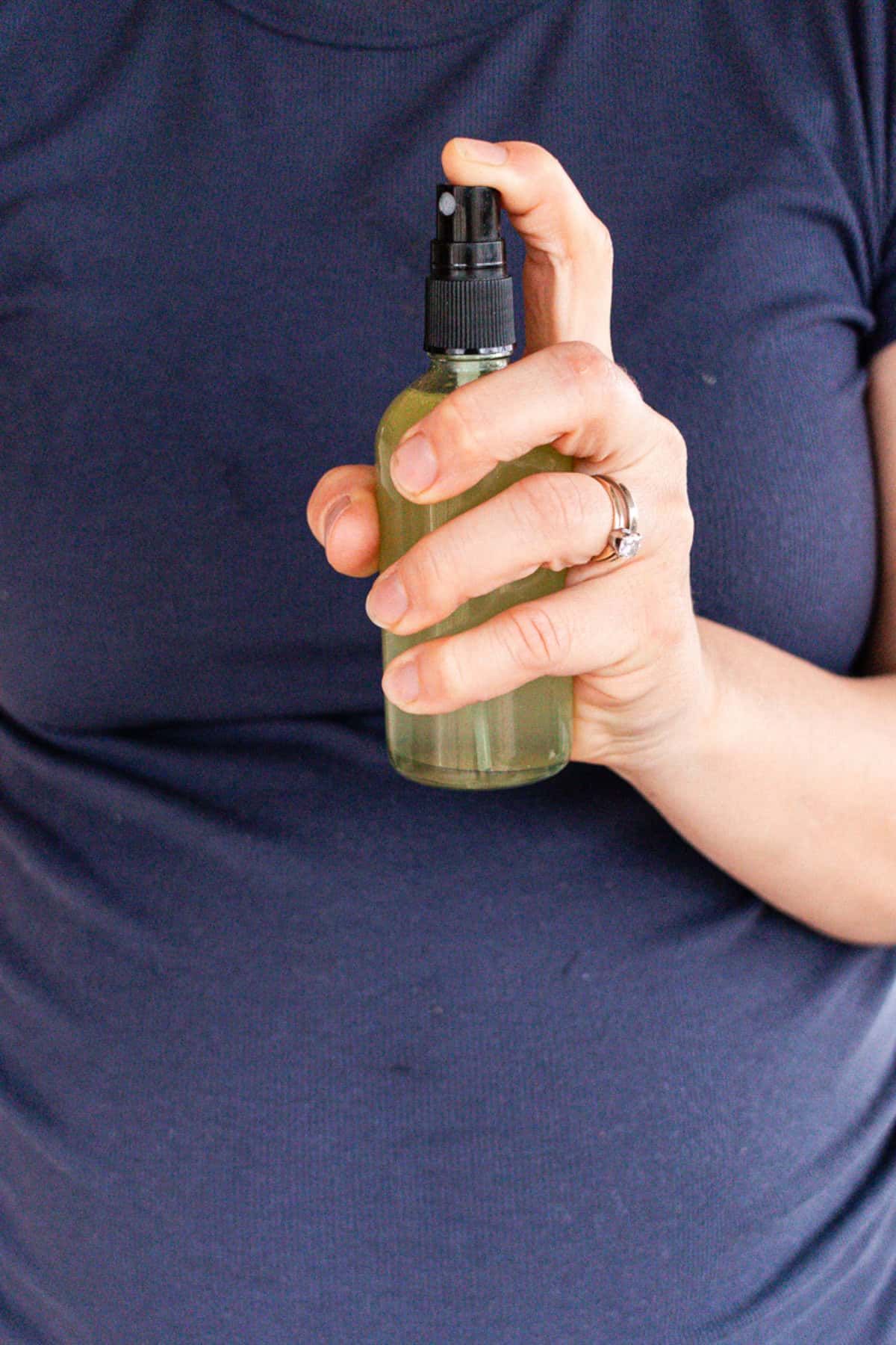 Spraying a spray bottle of whole body perfume.