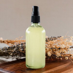 A bottle of whole body deodorant on a wooden board.