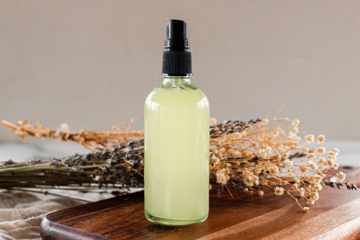 A bottle of whole body deodorant on a wooden board.