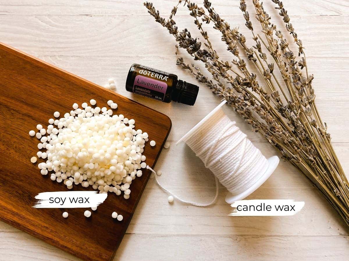 Mason jar candle ingredients on a white table.