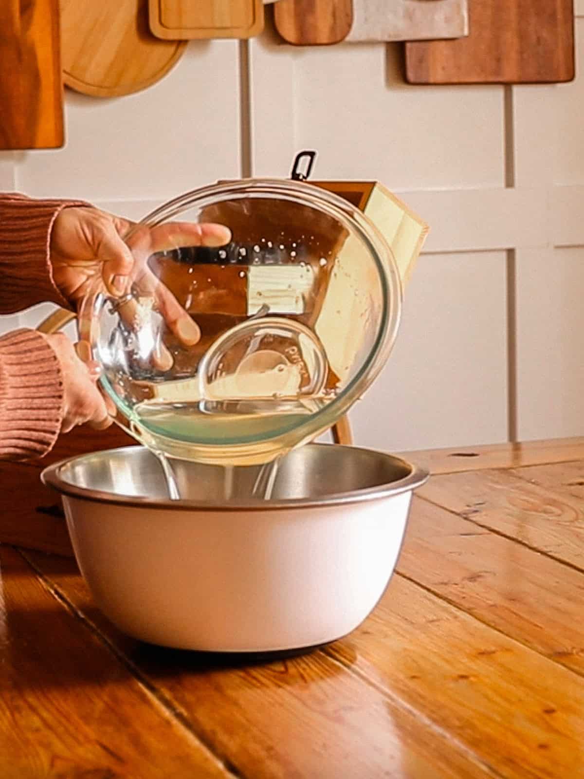 Pouring melted oils into another bowl.