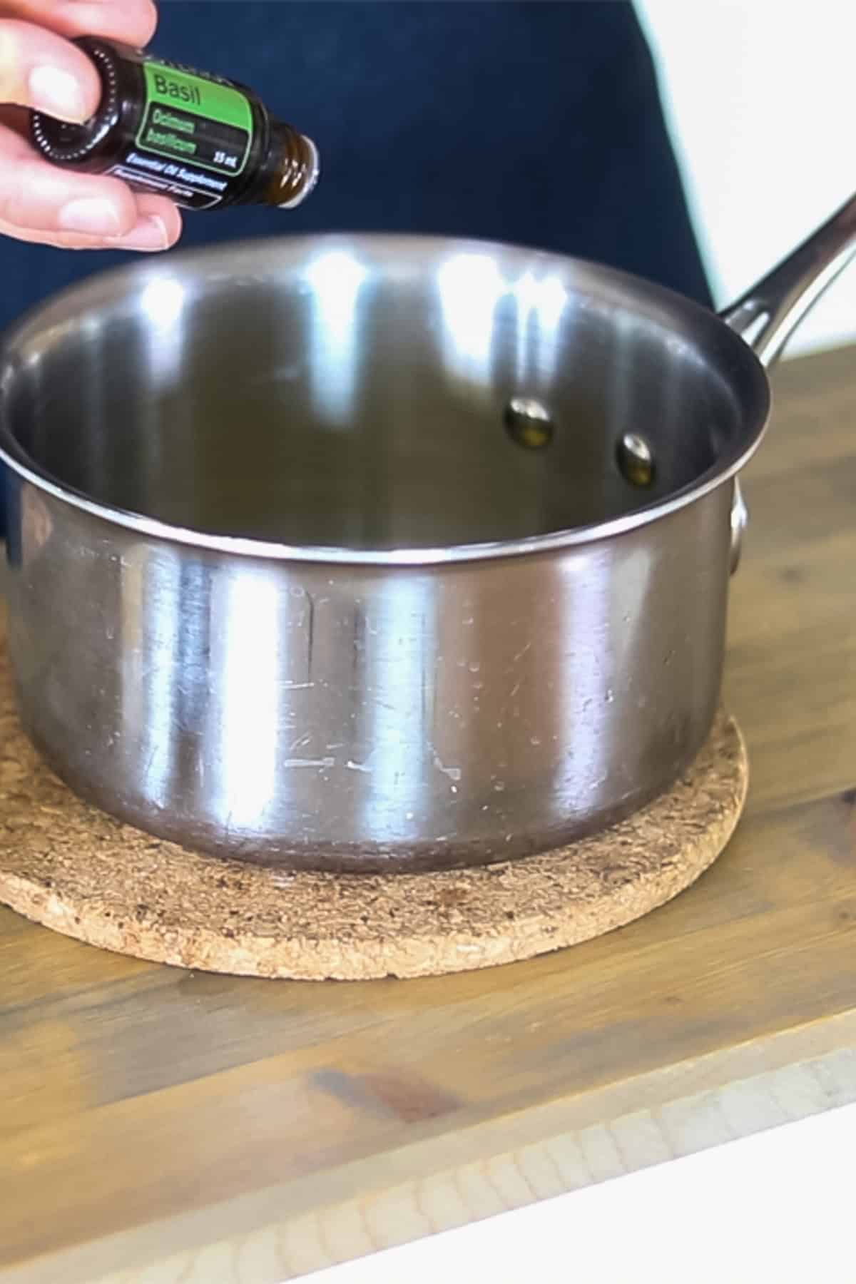 Adding the essential oils to the melted ingredients. 