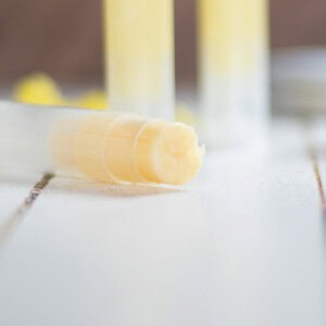 A small tube of homemade anti itch cream laying on its side with several more tubes behind it.