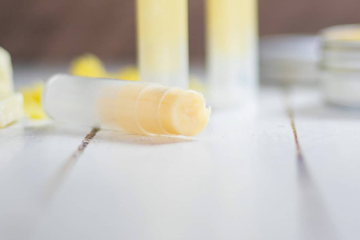 A small tube of homemade anti itch cream laying on its side with several more tubes behind it. 