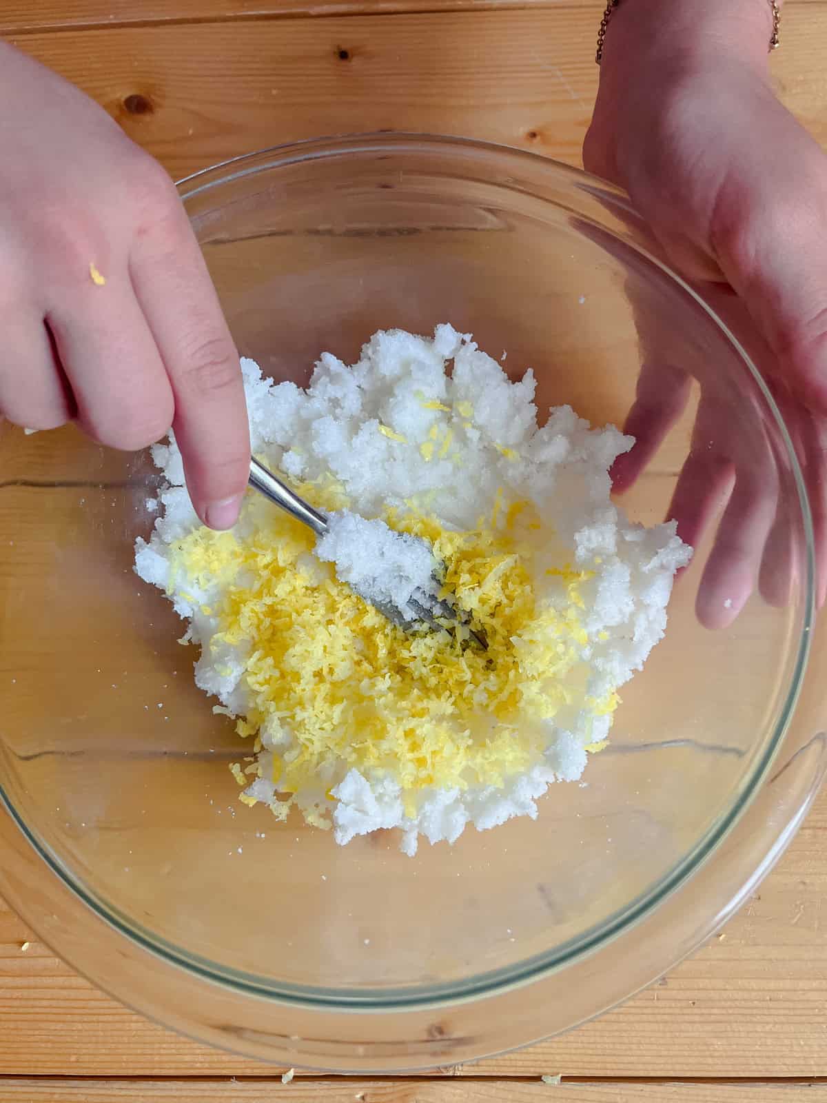 Stirring lemon zest into hand scrub.