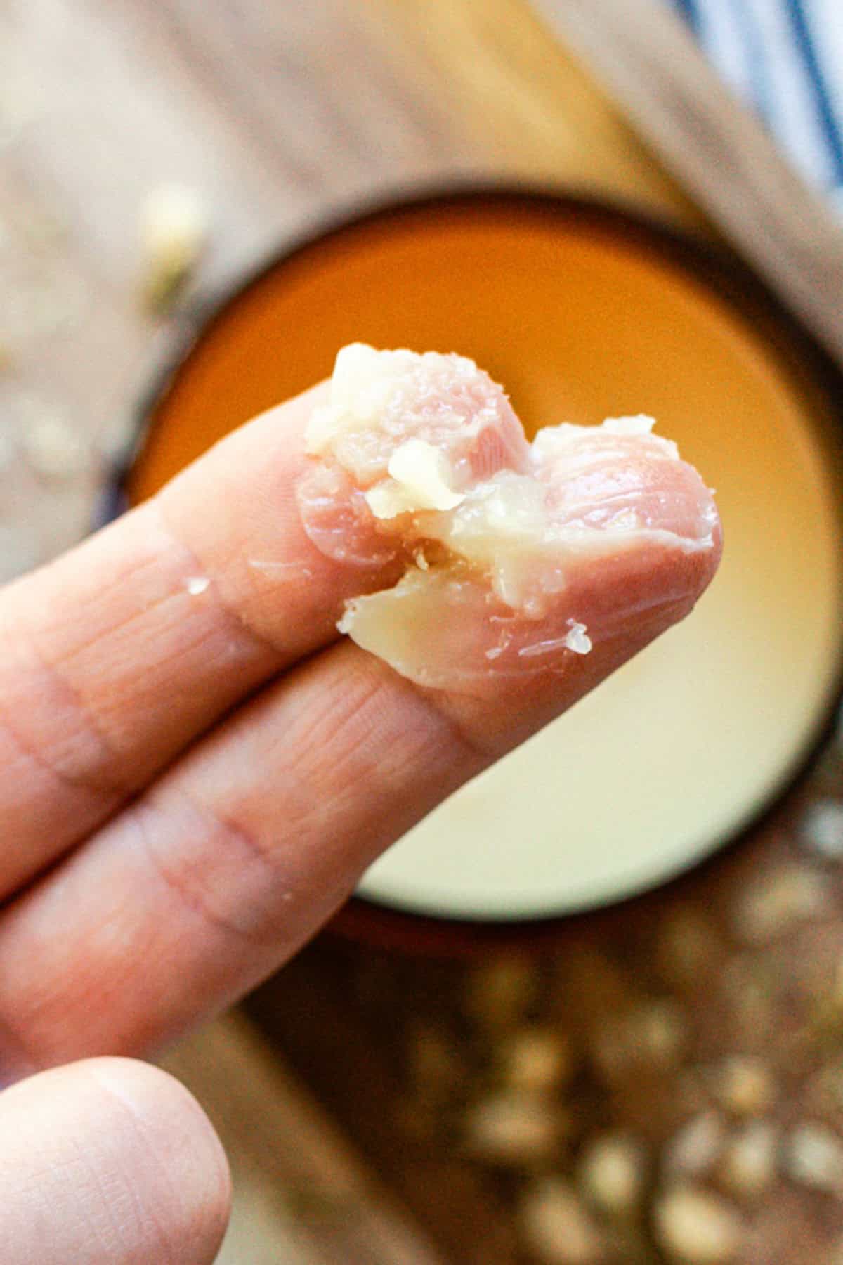 Applying tallow balm using two fingers. 