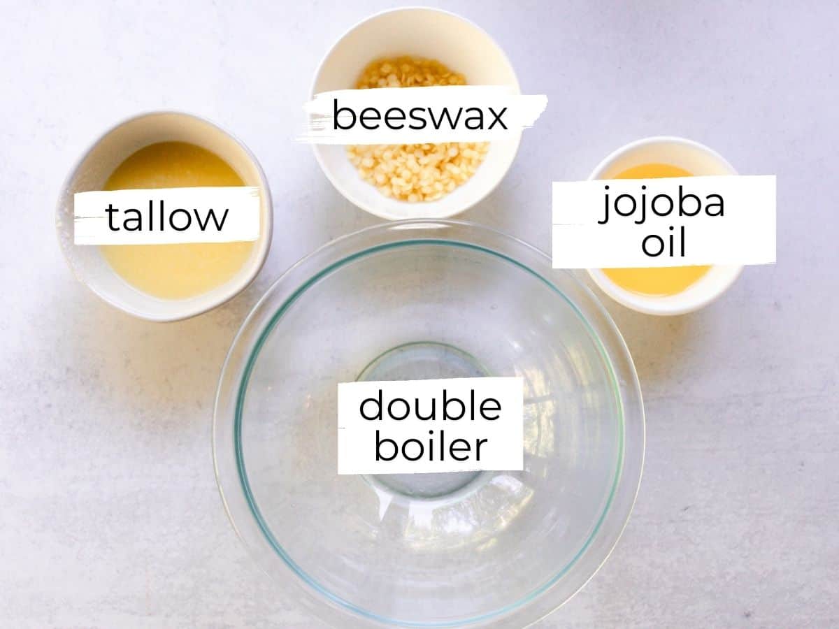Tallow balm ingredients assembled on a white table.