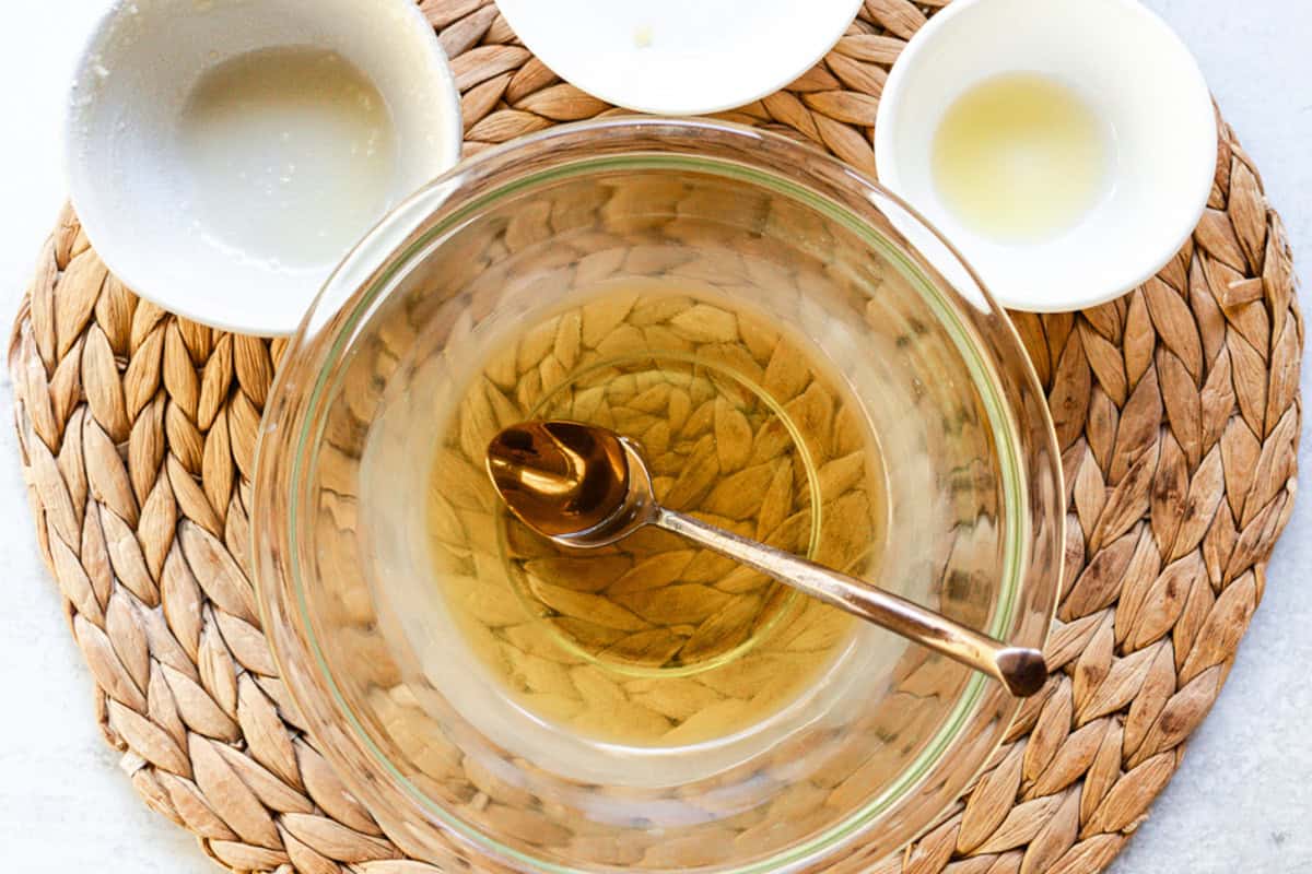 Stirring melted tallow balm ingredients.