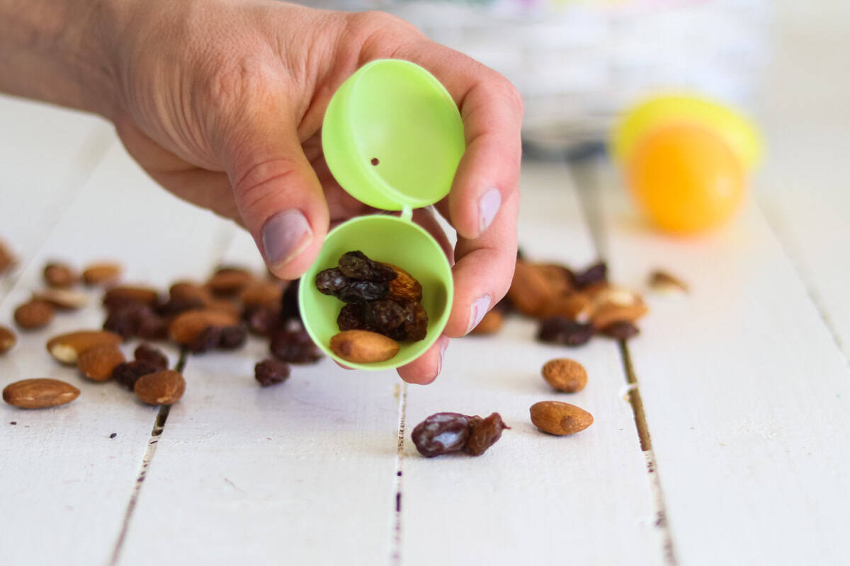 A plastic Easter egg filled with trail mix.