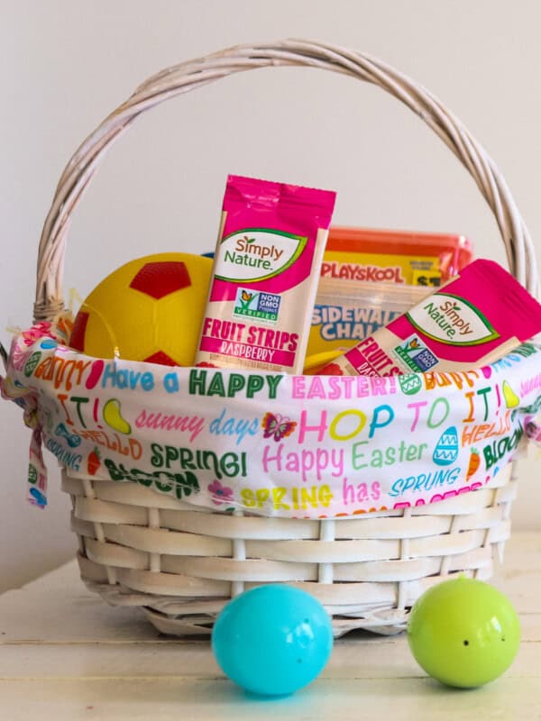An Easter basket filled with non-candy treats and two plastic Easter eggs.